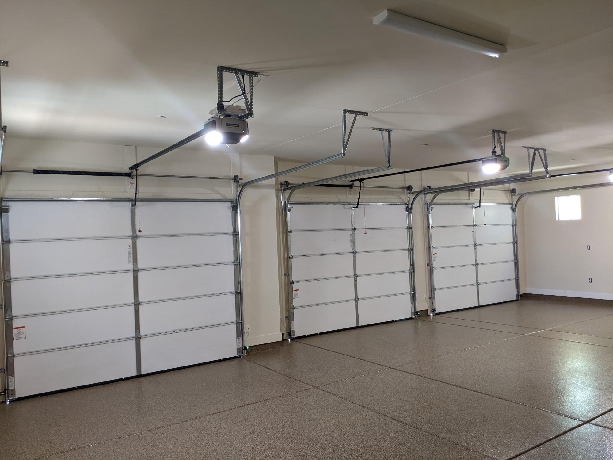 Triple-bay garage with new openers and clean rail systems installed